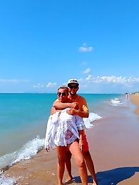 A more experienced woman is exposing her breasts in a sexual manner.